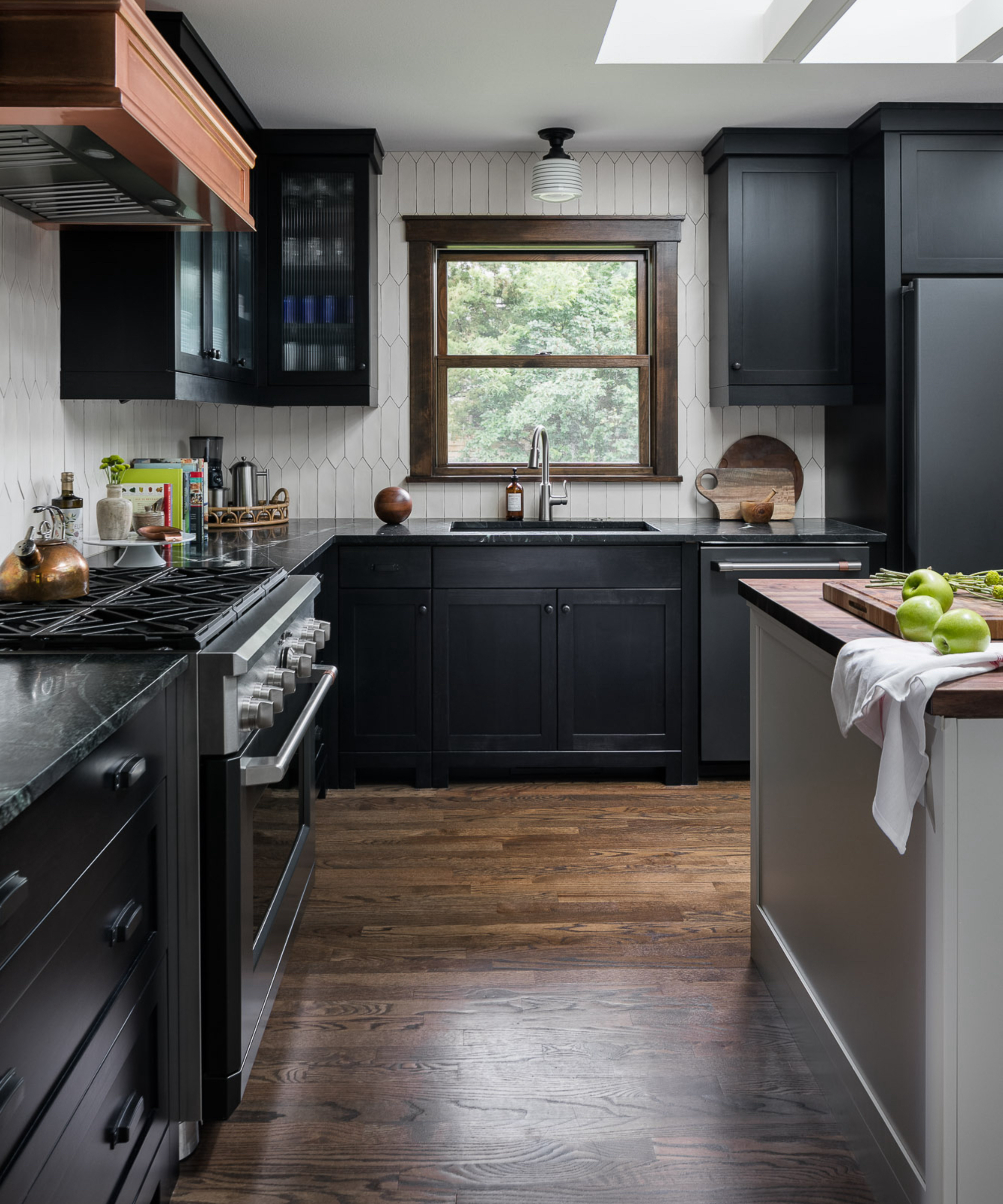 Stylish modern kitchen with dark cabinetry and pendant lights